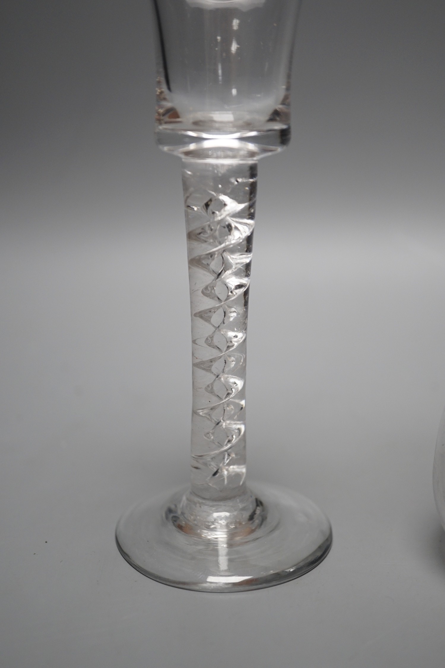 A George II mercury twist stem glass, a George III hollow stem glass, a toddy lifter and an air twist glass, tallest 17cm (4)